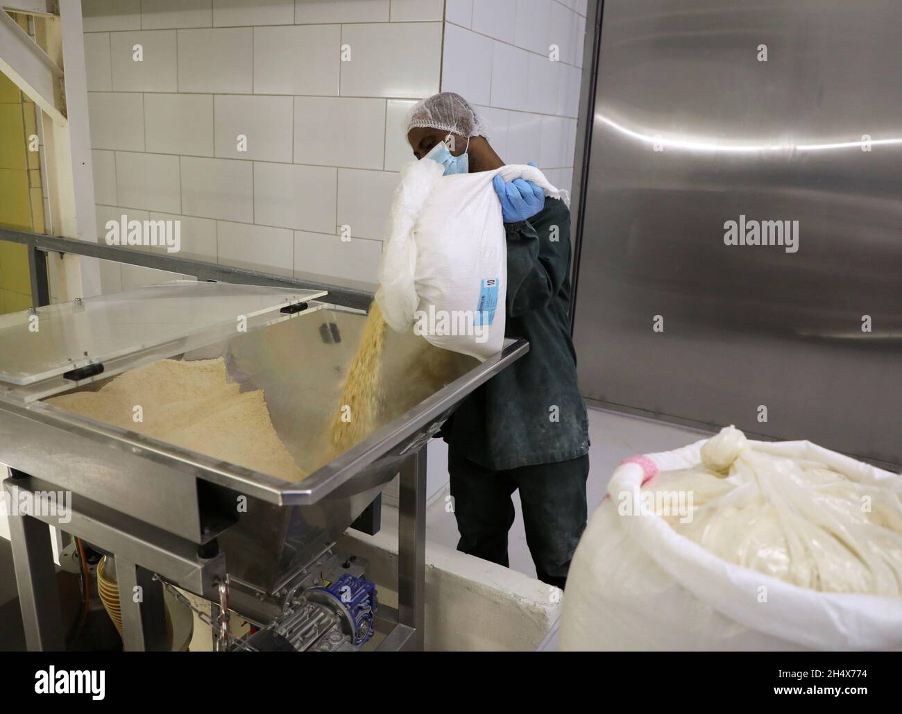 A worker works at Second House Products, a company that makes spice