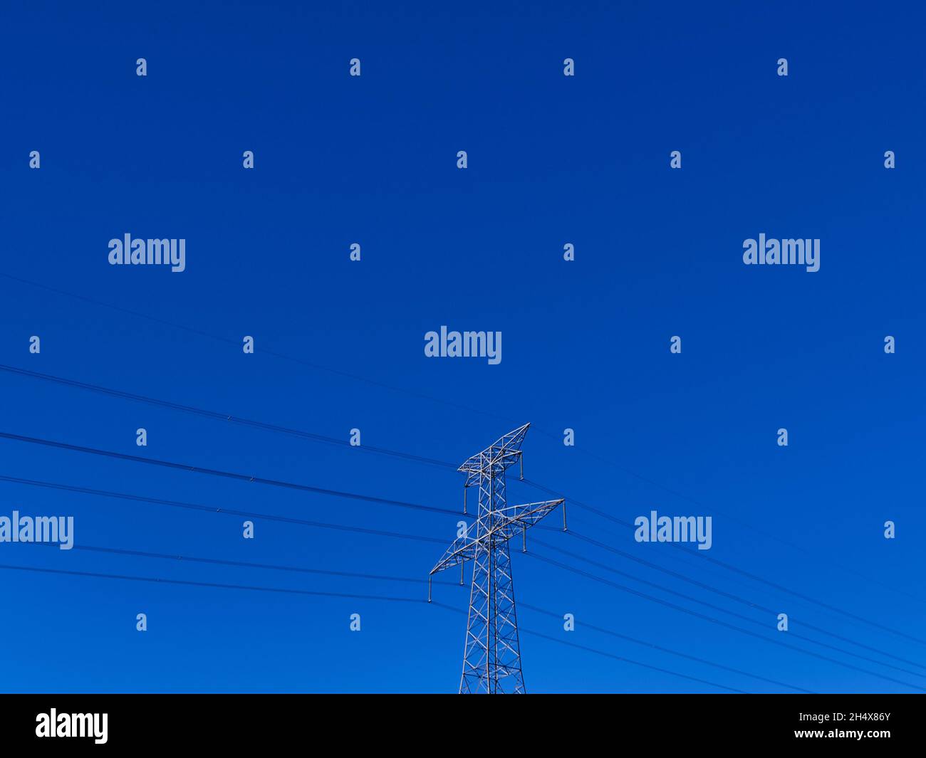 high voltage electric tower on clean blue sky Stock Photo - Alamy