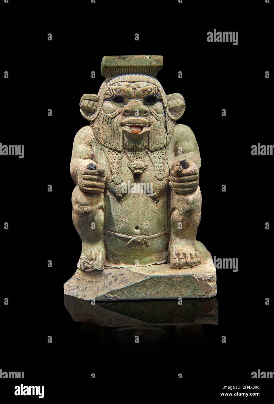 Egyptian statue sculpture of the god Bes, 664-525 BC, 16th dynasty,  . Louvre Museum E10929.  Bes is squatting wearing the panther skin, beard, protru Stock Photo