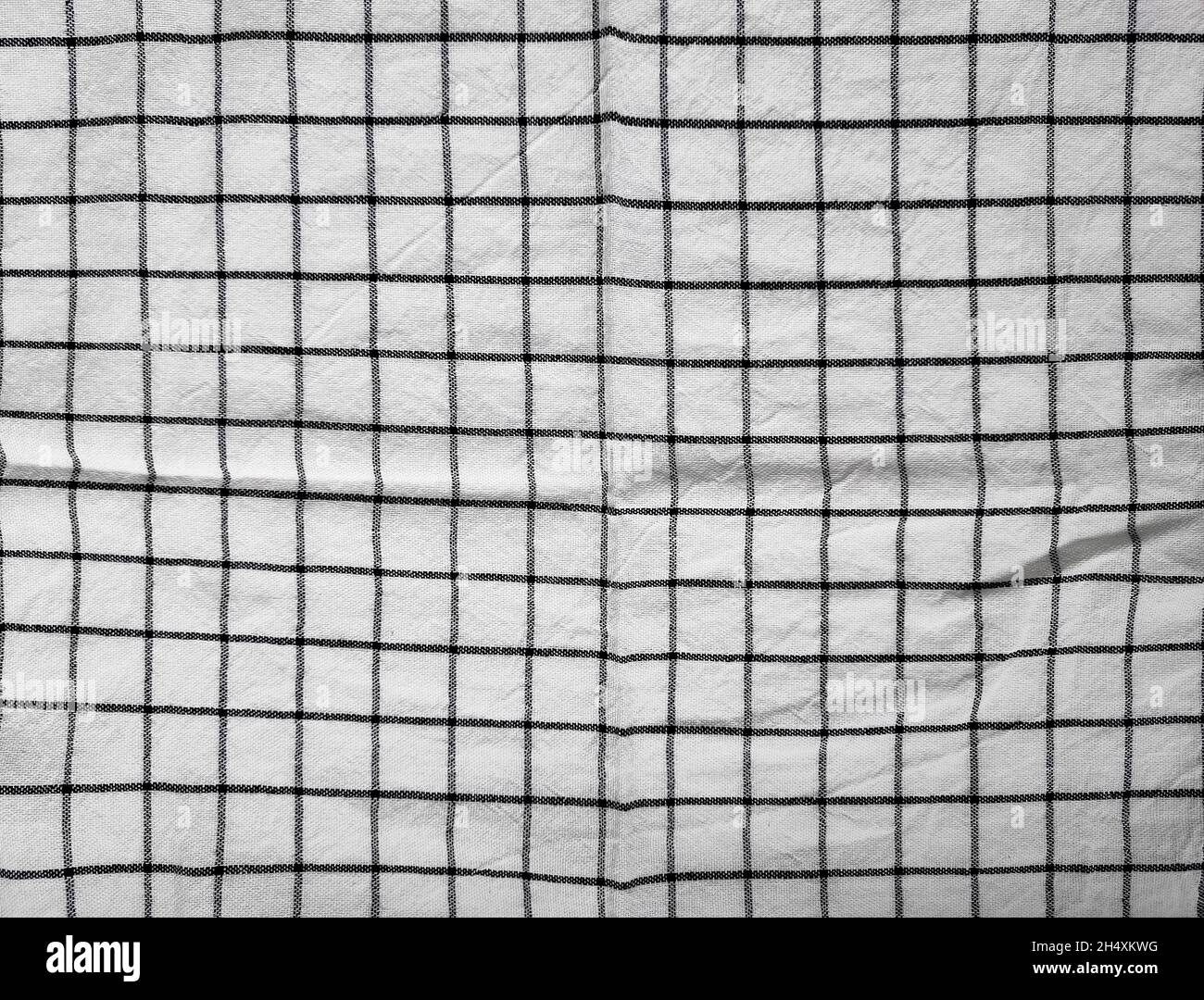 Checkered tablecloth fabric or towel. Black with white square pattern as background Stock Photo