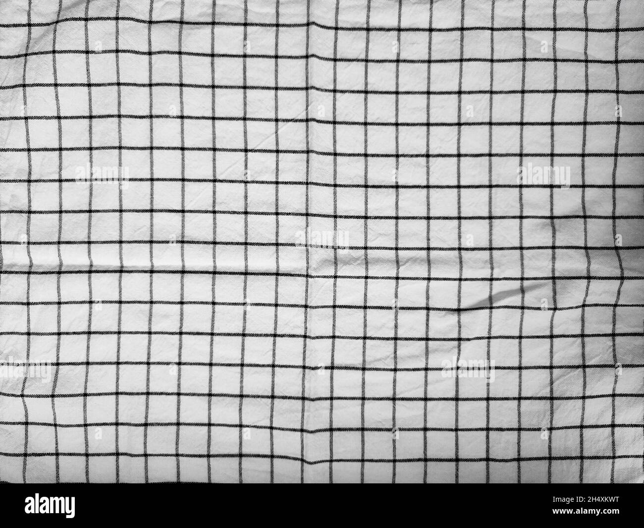 Checkered tablecloth fabric or towel. Black with white square pattern as background Stock Photo