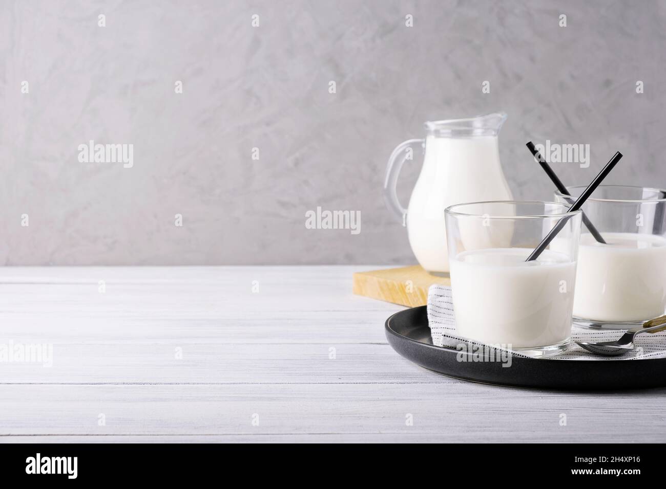 Glass serving vessels with milk. Healthy dietary food, dairy products Stock Photo