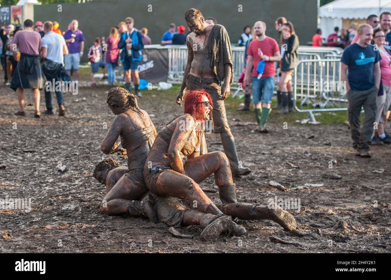 Festival goers wrestling in the mud on day 2 of V Festival on August 23 2015 at Weston Park, Staffordshire, UK Stock Photo