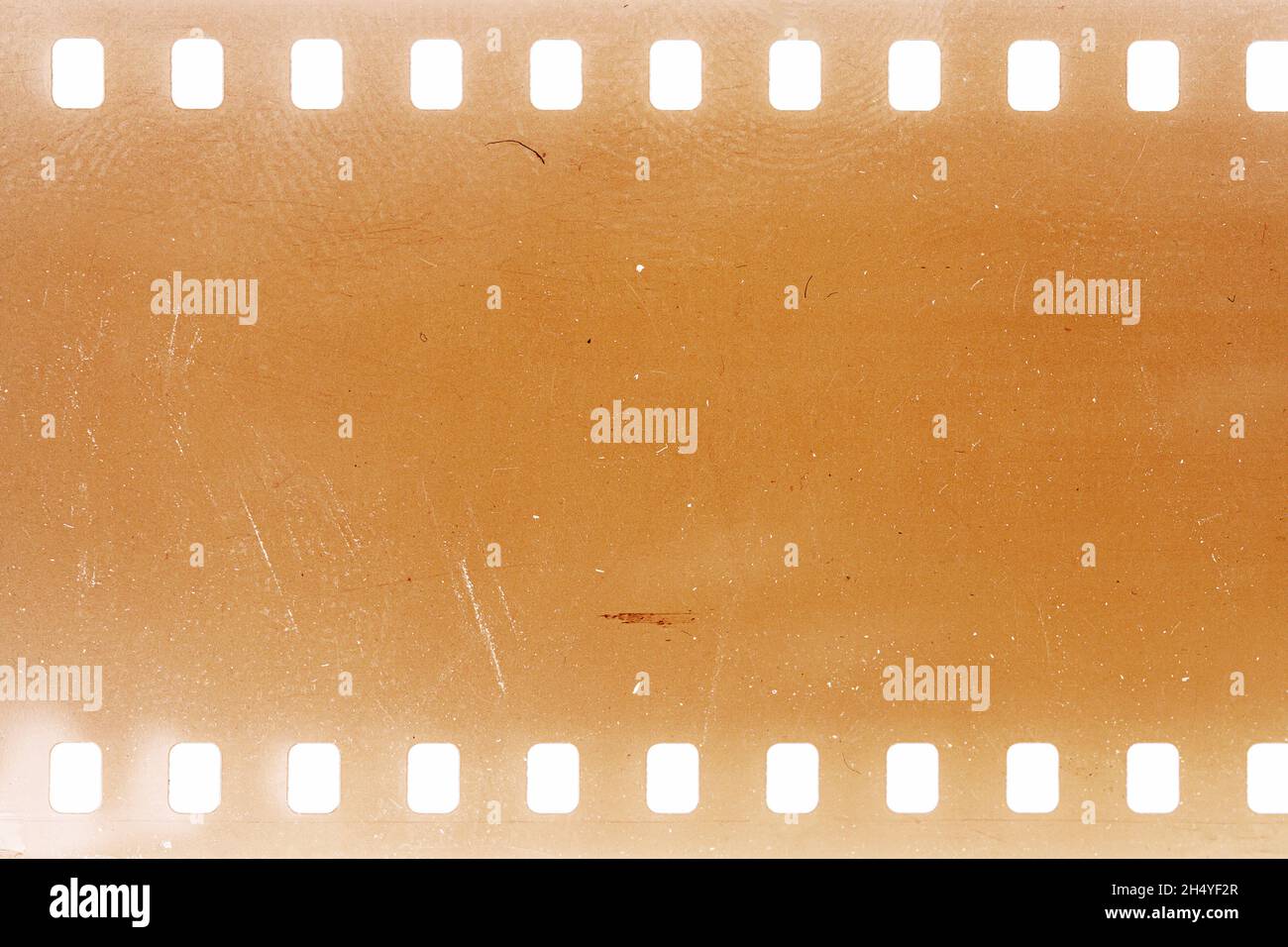 Dusty and grungy 35mm film texture or surface. Perforated camera film