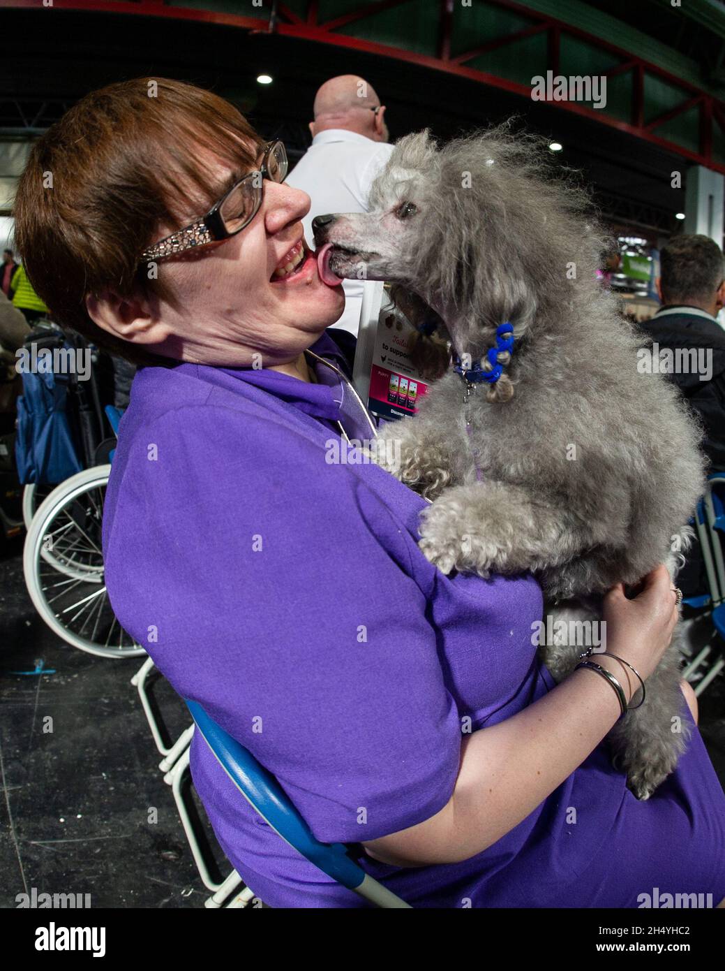 Woman holds her Miniature Poodle on day 4 of Crufts Dog Show at the National Exhibition Centre (NEC) on 10 March 2019 in Birmingham, England. Picture date: Sunday 10 March, 2019. Photo credit: Katja Ogrin/ EMPICS Entertainment. Stock Photo