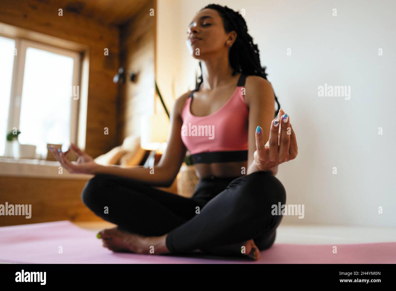 Young black woman meditating home hi-res stock photography and images ...