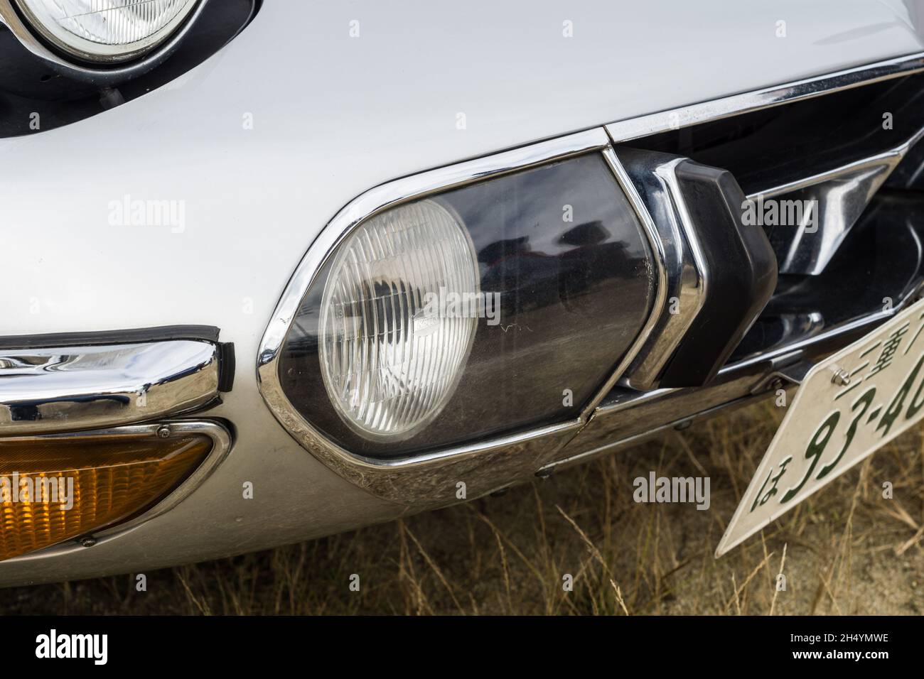 Close up detail of the headlight and grille on a silver Toyota 2000 GT ...