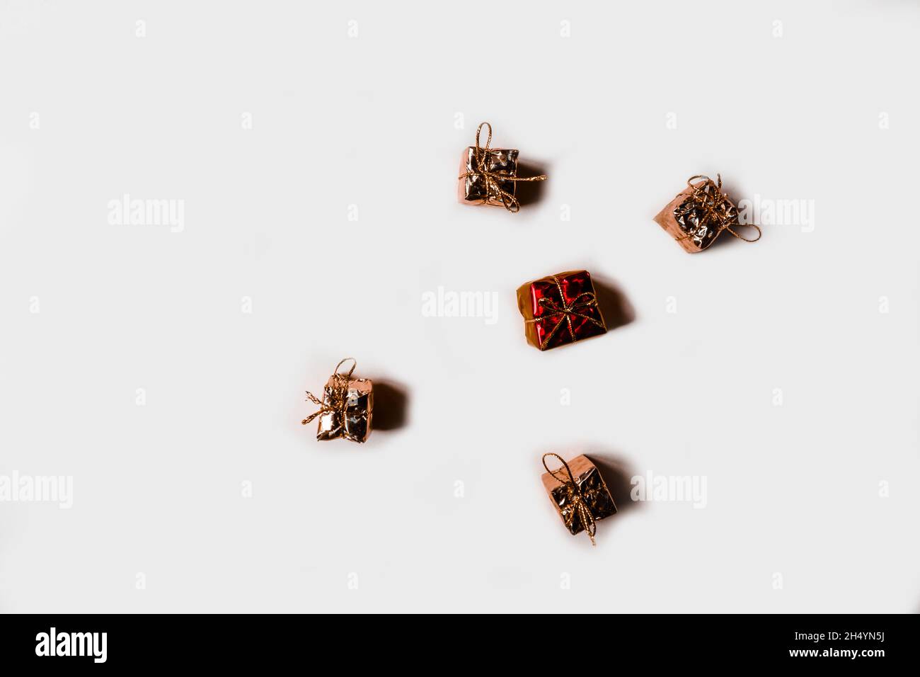 Five small gifts lie on a white background. View from above. Stock Photo