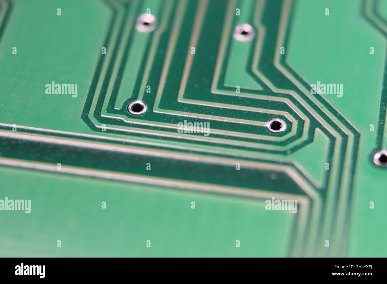 Macro shot of a green electronic board with circuit lines and chips ...