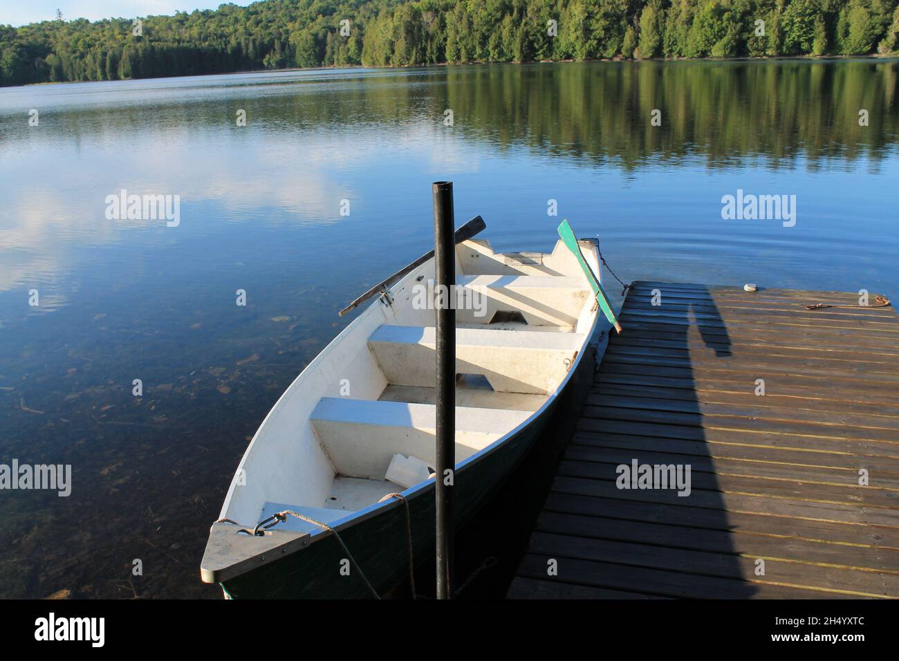 A sailing boat at lake des Ecorces in Quebec Canada. The calmness of the water, an amazing view of trees. Stock Photo