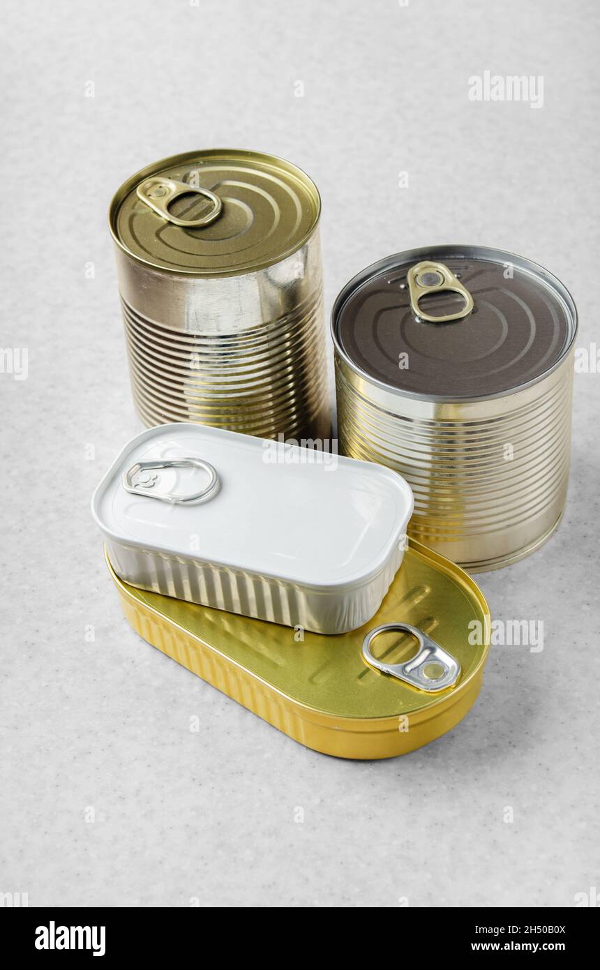 Set of various canned foods in tin cans on kitchen table, non-perishable, long shelf life food for survival in emergency conditions concept Stock Photo