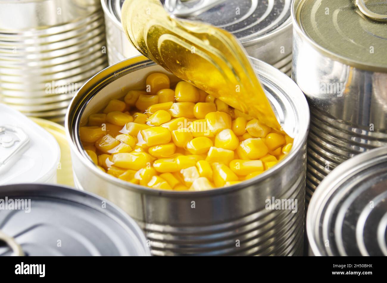 Canned sweet corn in just opened tin can. Non-perishable food Stock Photo