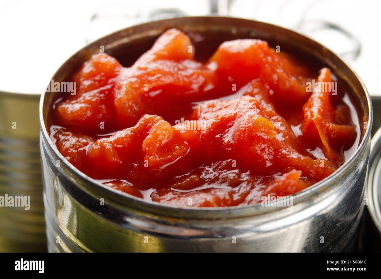 Canned sliced tomatoes in just opened tin can. Nonperishable food