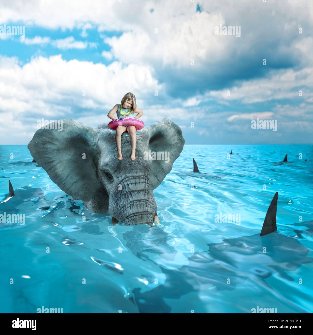 sad little girl on elephant in the sea full of sharks Stock Photo