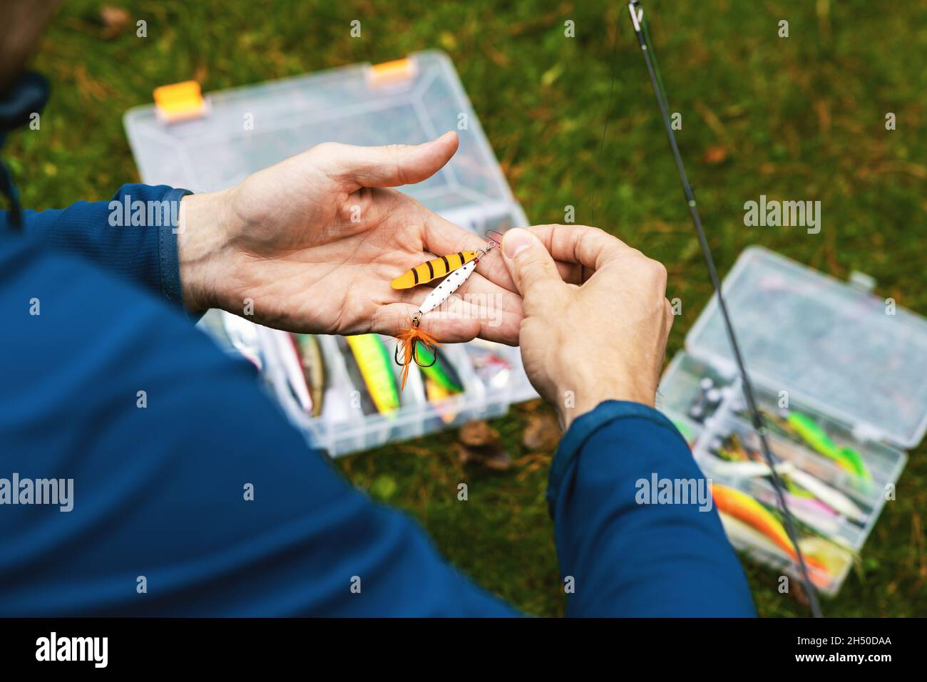 fisherman putting on the spinner lure Stock Photo Alamy