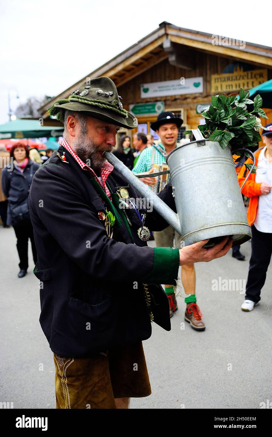 Vienna, Austria. April April 12, 2011.  Styria village on Vienna City Hall Square. Man uses a watering can as an instrument Stock Photo