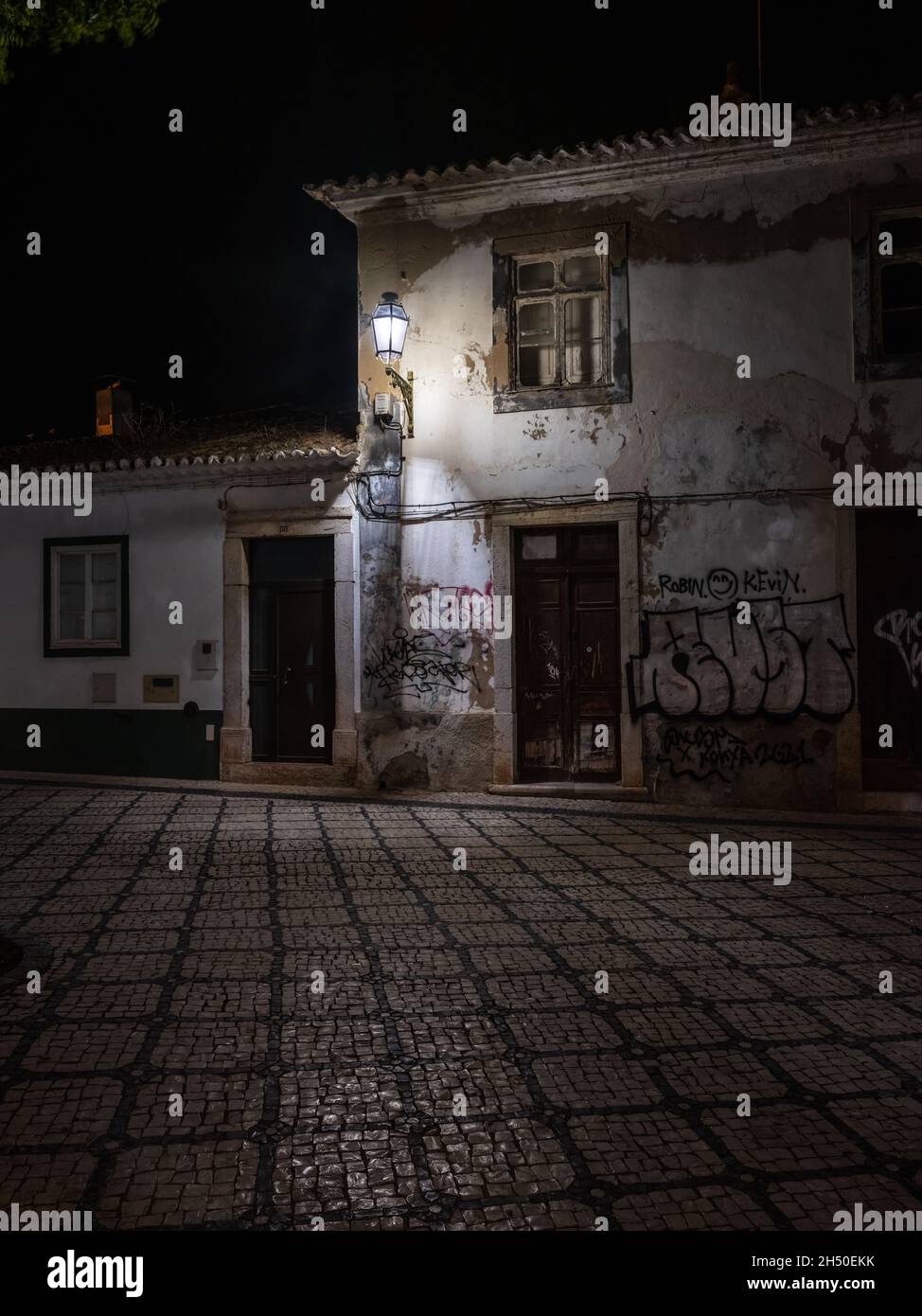 Lagos, Algarve, Portugal - November 2 2021: Rundown and decaying building with broken windows covered in graffiti on Rua Marreiros in historic centre Stock Photo