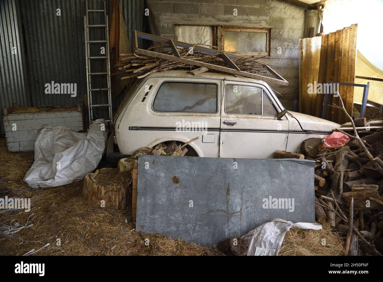 Abandoned Lada Niva in Old or Ramshackle Shed in the Alpes-de-Haute-Provence Provence France Stock Photo