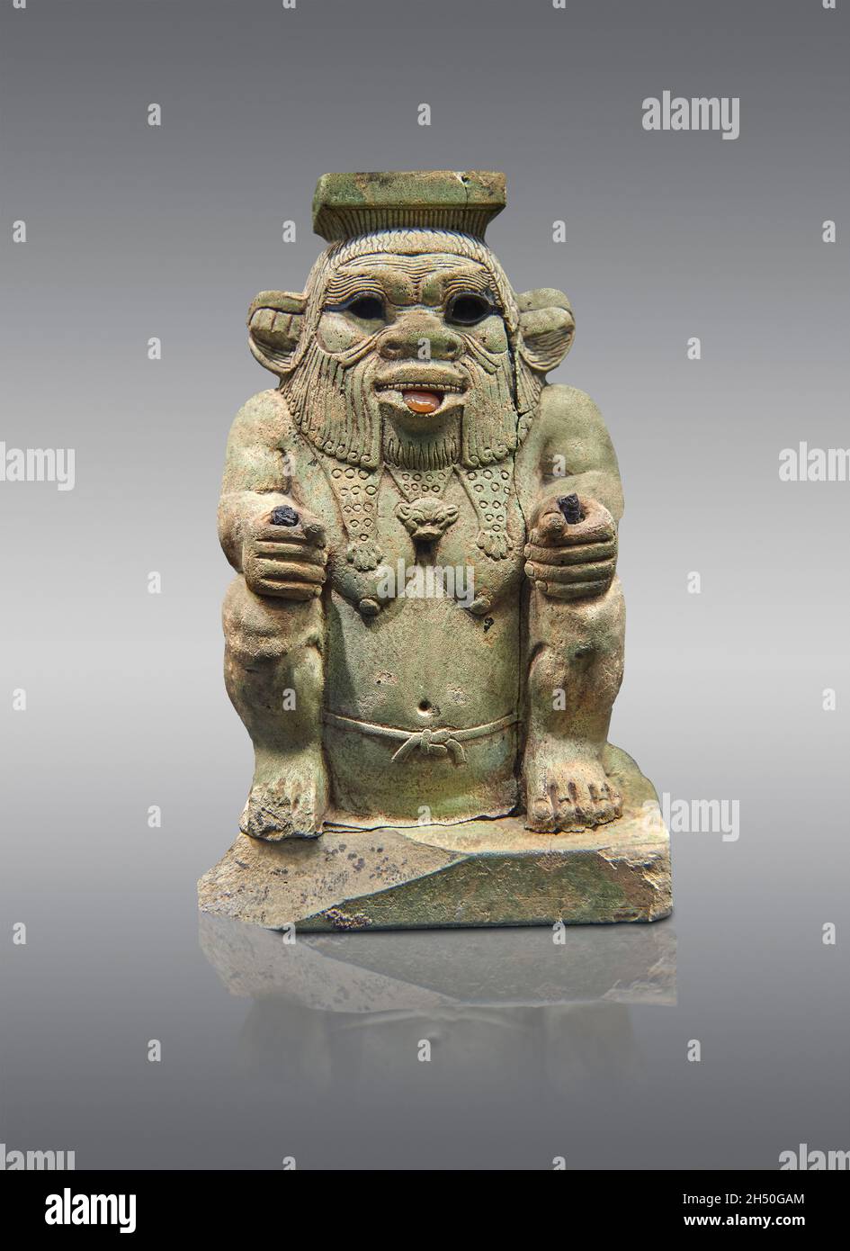 Egyptian statue sculpture of the god Bes, 664-525 BC, 16th dynasty,  . Louvre Museum E10929.  Bes is squatting wearing the panther skin, beard, protru Stock Photo