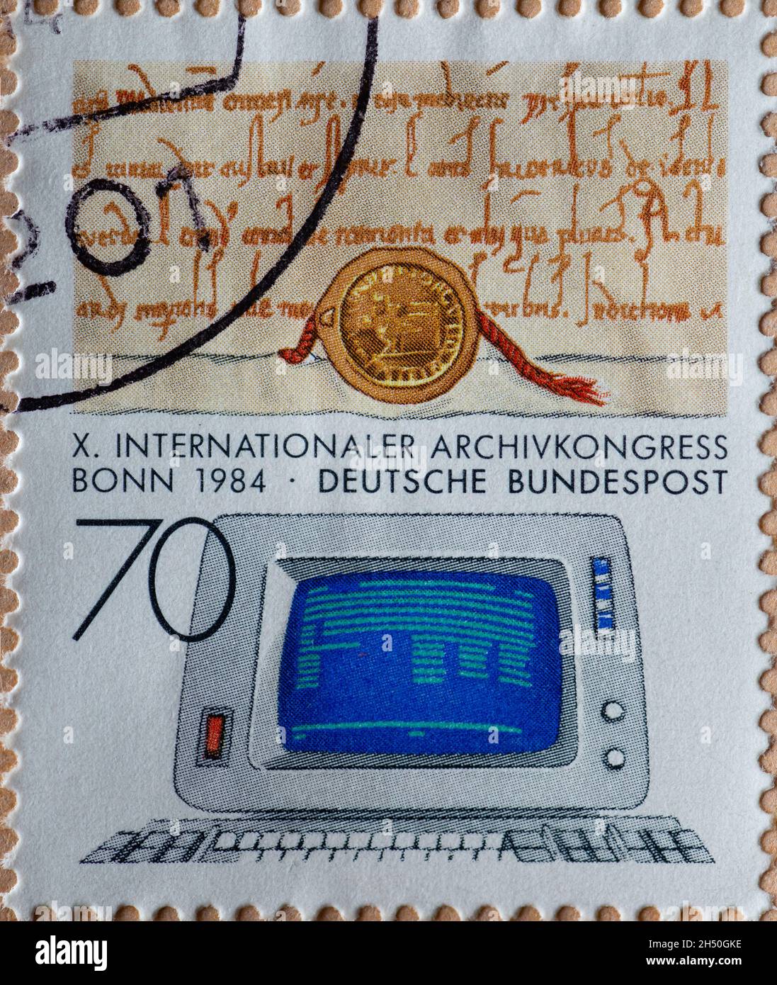 GERMANY - CIRCA 1984  : a postage stamp from Germany, showing a document from the Middle Ages and an outdated data display device. International Archi Stock Photo