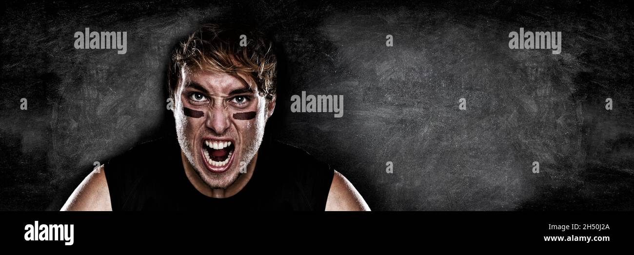 American football player screaming on black chalkboard texture background copy space for advertising. Panoramic banner blackboard with man athlete Stock Photo
