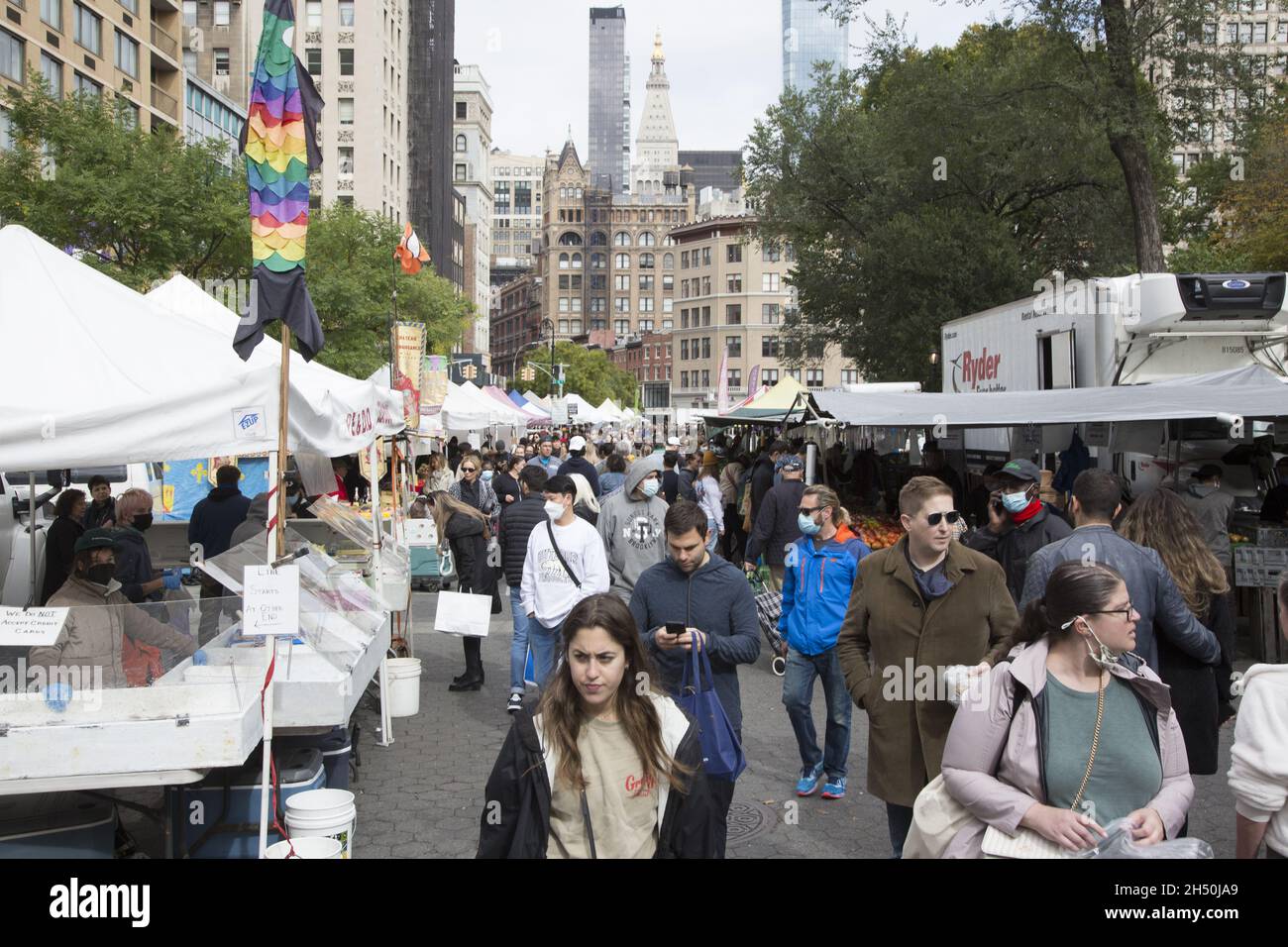 Looking north in the Union Square Farmers Market that is always crowded with shoppers and strollers, NYC. Stock Photo