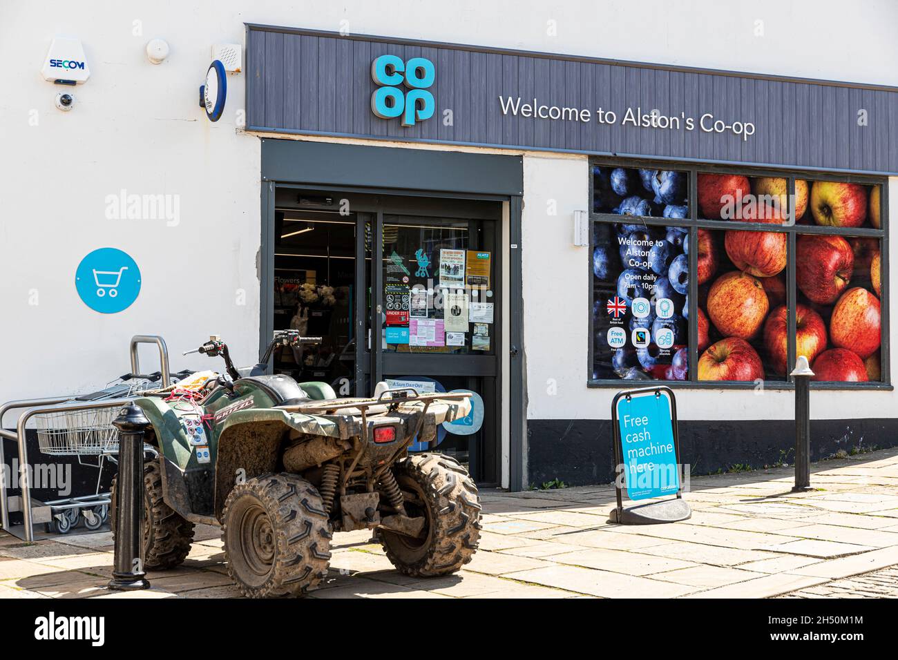 A quad bike parked outside of the Co-op supermarket in the upland Pennines town of Alston, Cumbria UK Stock Photo