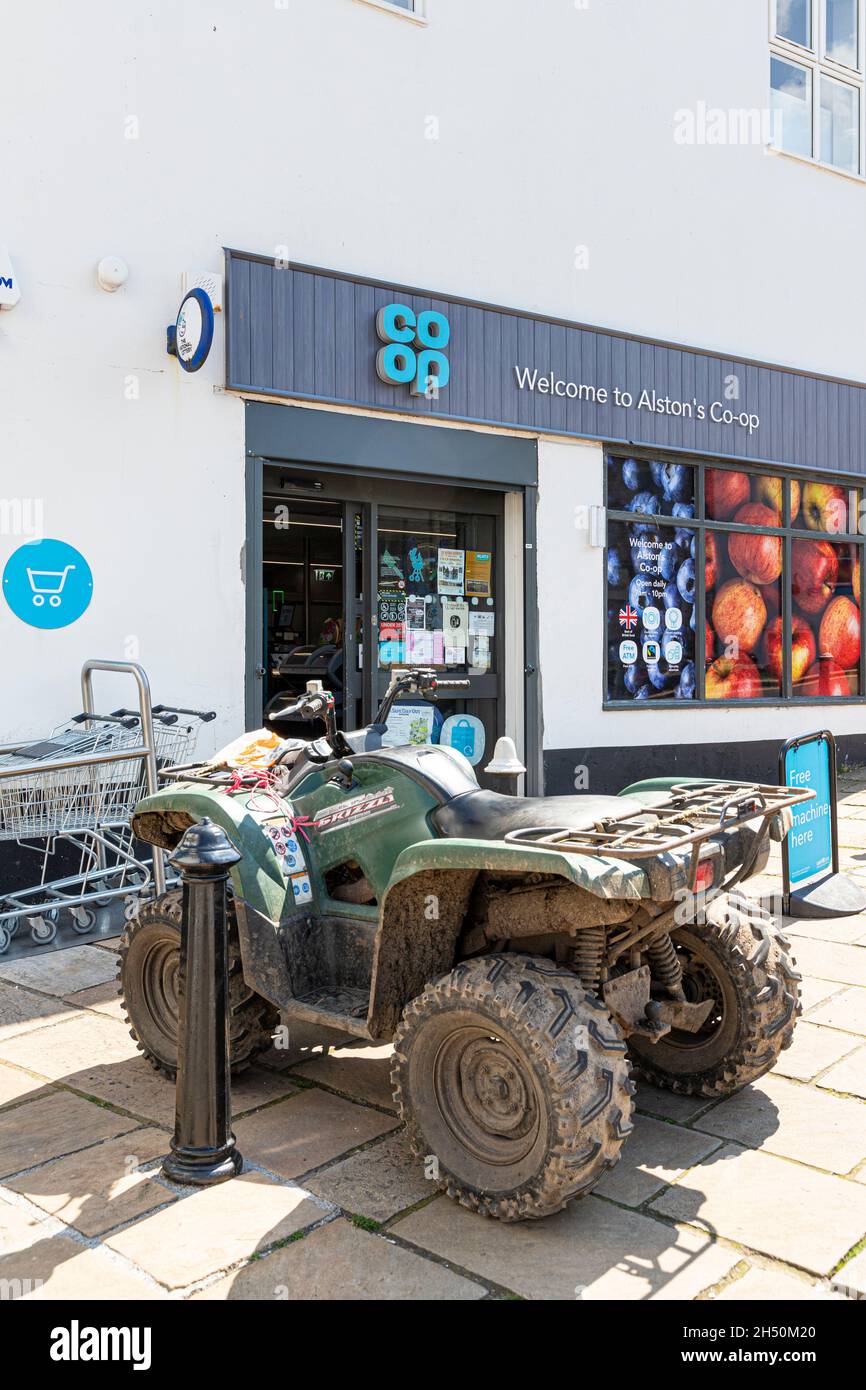 A quad bike parked outside of the Co-op supermarket in the upland Pennines town of Alston, Cumbria UK Stock Photo