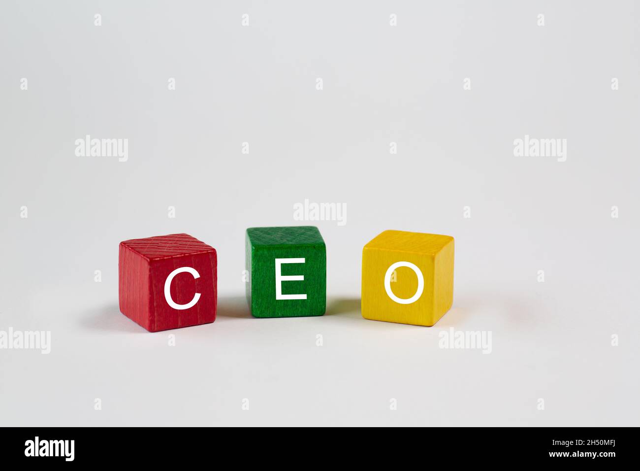 colored blocks against an isolated white background contain the letters CEO, which stand for Chief Executive Officer. Free space is available in this Stock Photo