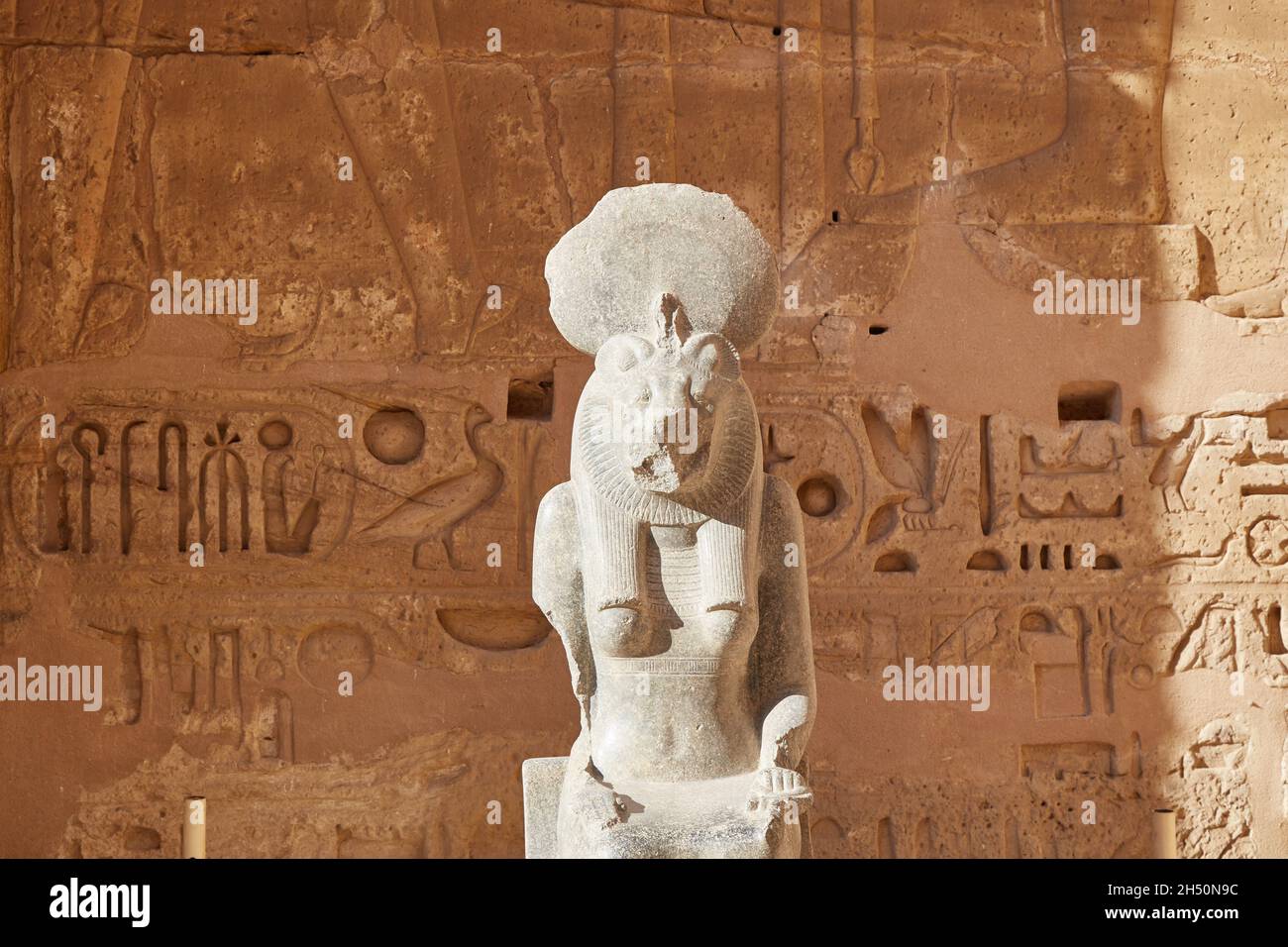 A granite seated statue of the lioness goddess Sekhmet at Medinet Habu ...
