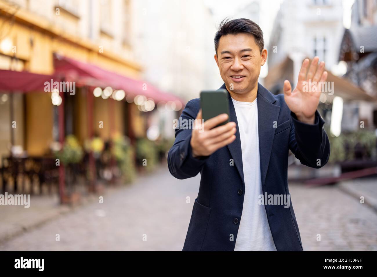 Business man having video call on hone outdoors Stock Photo