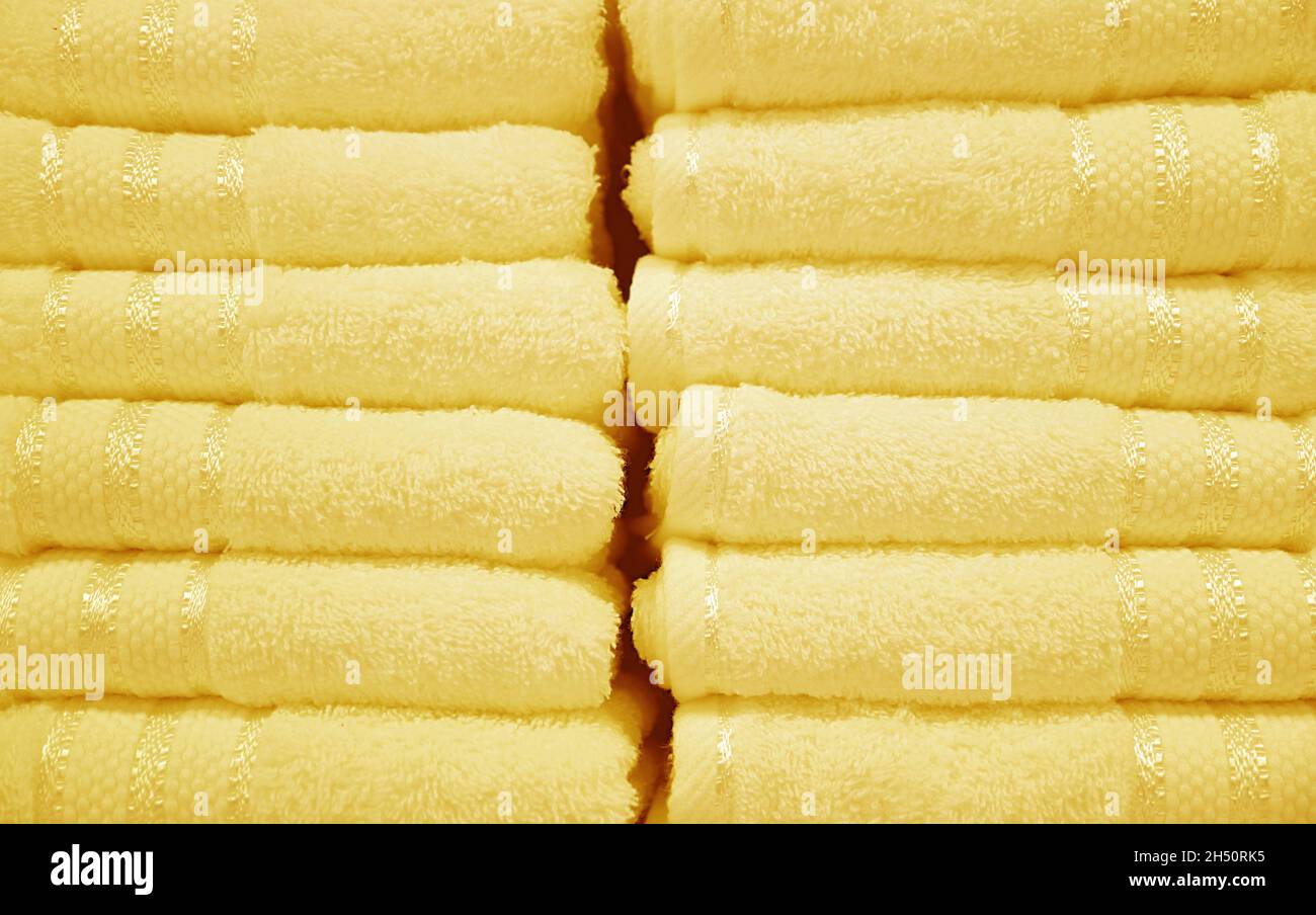 Front View of Pastel Butter Yellow Fluffy Towels Stack Stock Photo