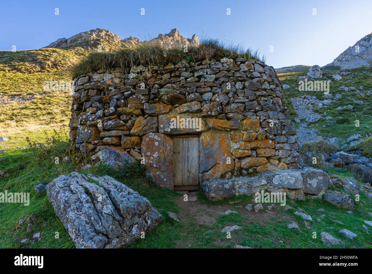 Hut, corro, made of stone with a broom roof, teito, in the Sousas valley in the Somiedo natural park in Asturias  Stock Photo