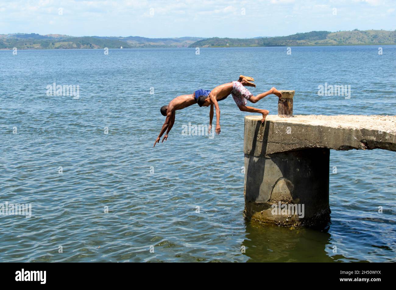 Cachoeira, Bahia, Brazil - November 29, 2014: Young people jumping from the deck of the Paraguacu River in Barra de Paraguacu, located in the Brazilia Stock Photo