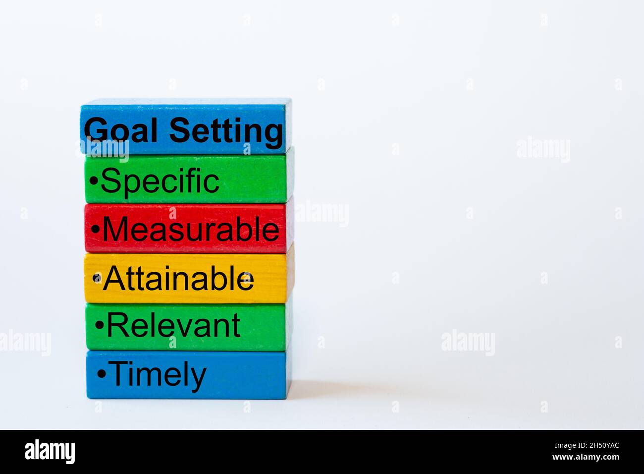The words: Goal Setting, Specific, Measurable, Attainable, Relevant, Timely are written on colorful blocks Stock Photo