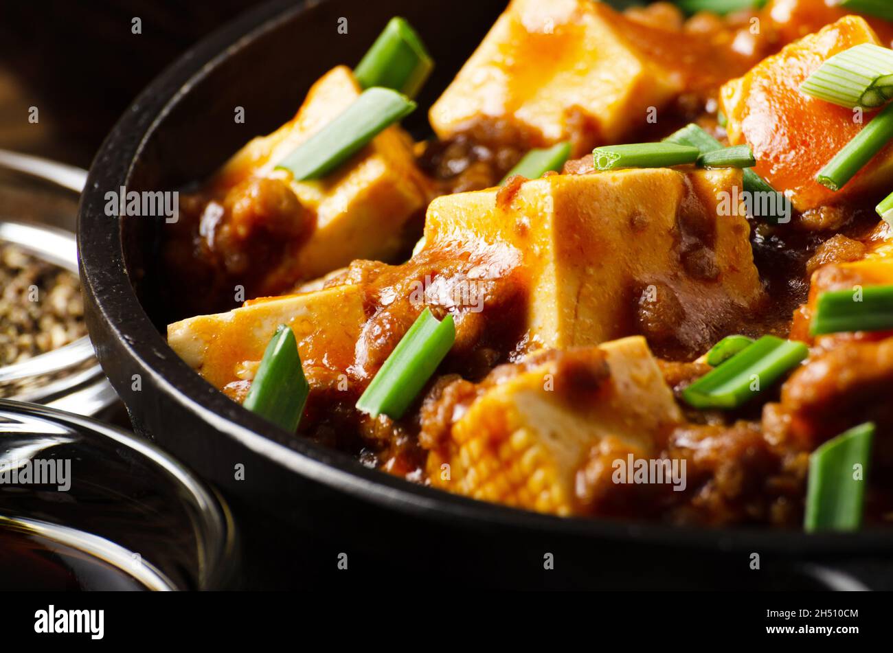 Mapo tofu in cast iron skillet with pork chopped chives soy sauce