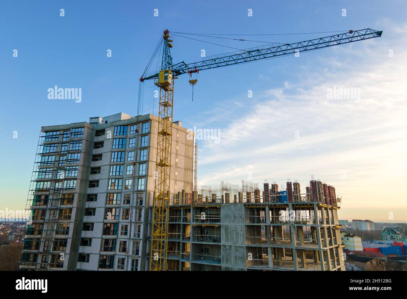 Aerial view of high tower crane and residential apartment buildings ...