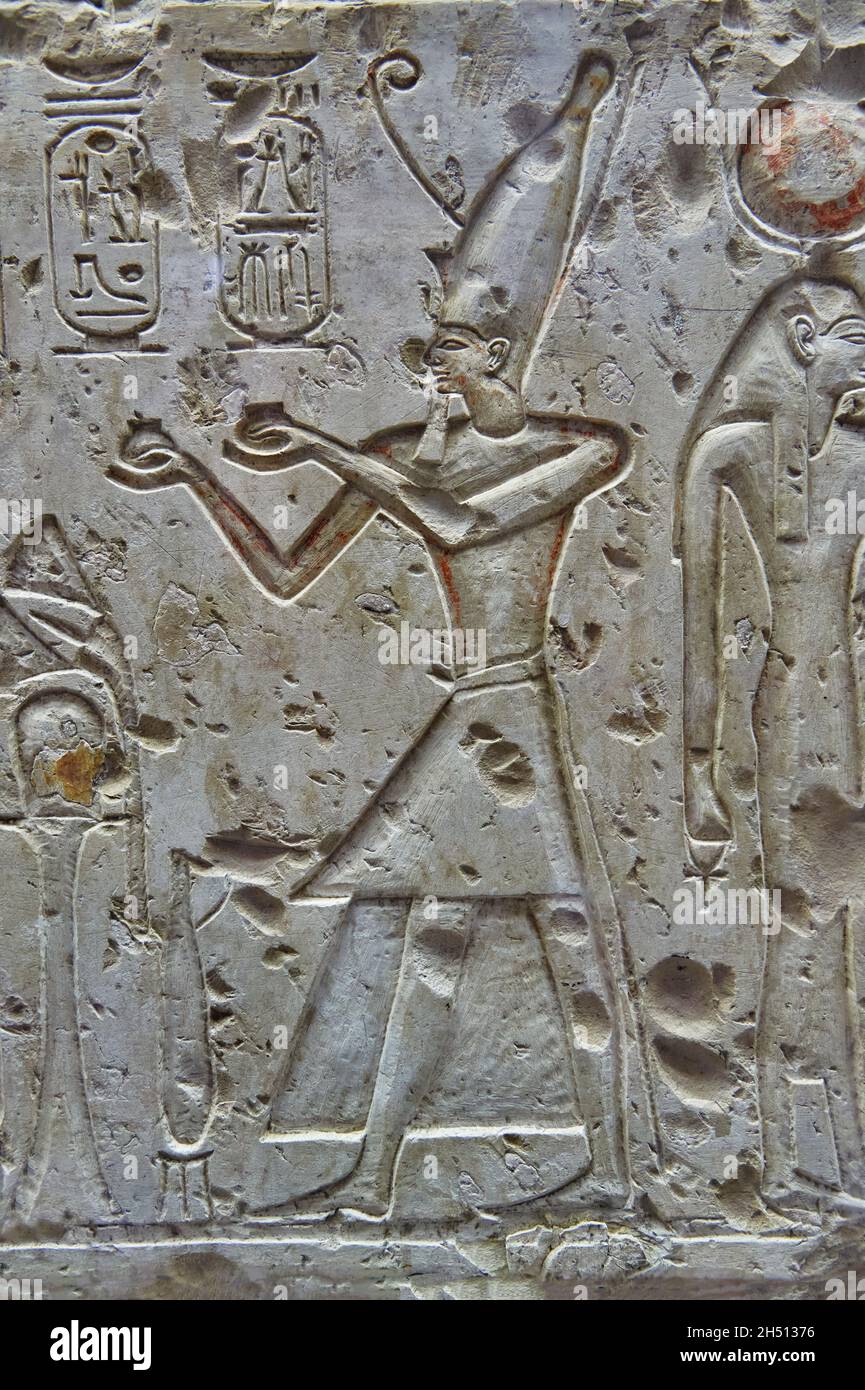 Ancient Egyptian relief mural of Ramesses II making offerings to Osiris, 1279-1213, Adydos. Louvre Museum B20 N132. In 2 scenes, from left - Rameses I Stock Photo