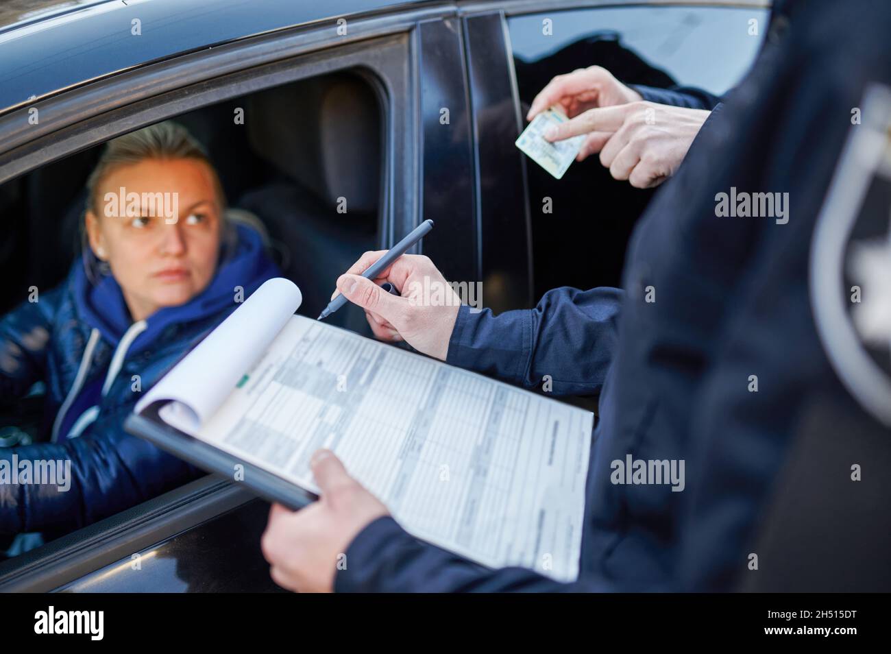 Police patrol checking driver's license of driver Stock Photo Alamy