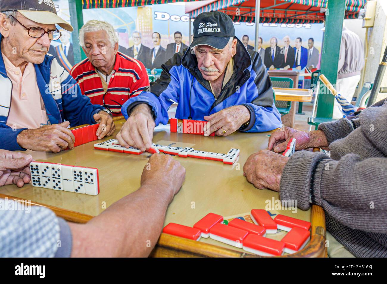 Miami Florida,Little Havana,Calle Ocho,Maximo Gomez Domino Park,Hispanic men male senior seniors citizens group dominoes tiles game Stock Photo