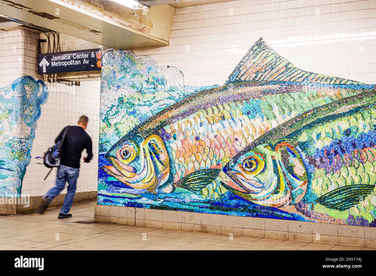 New York City,NY NYC Lower Manhattan,subway MTA,Delancey Street Station art artwork mural,Shad Crossing Ming Fay artist man male running mosaic tile Stock Photo