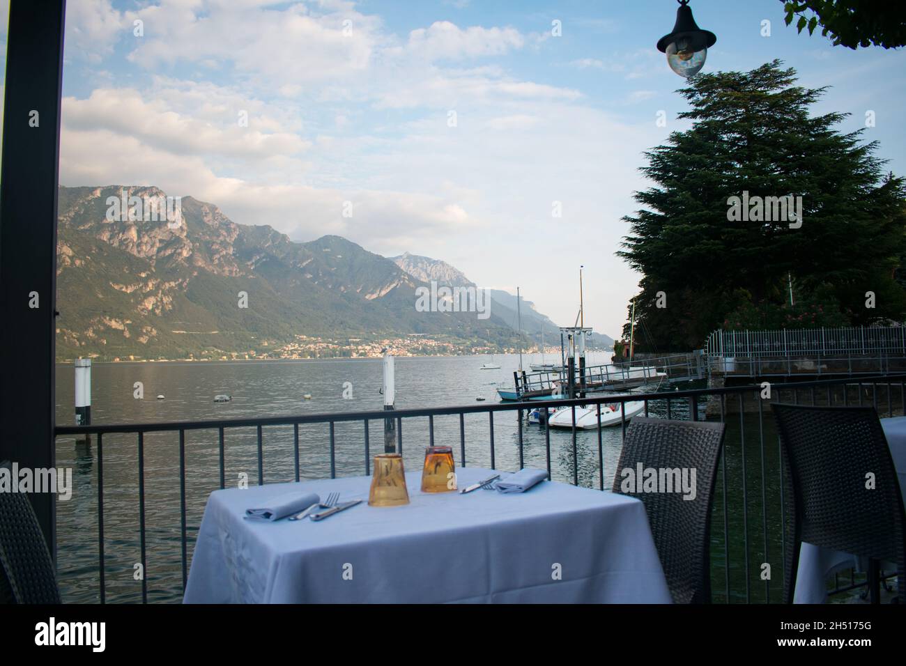 Dinner table set at a local restaurant overlooking Lake Como Italy Stock Photo