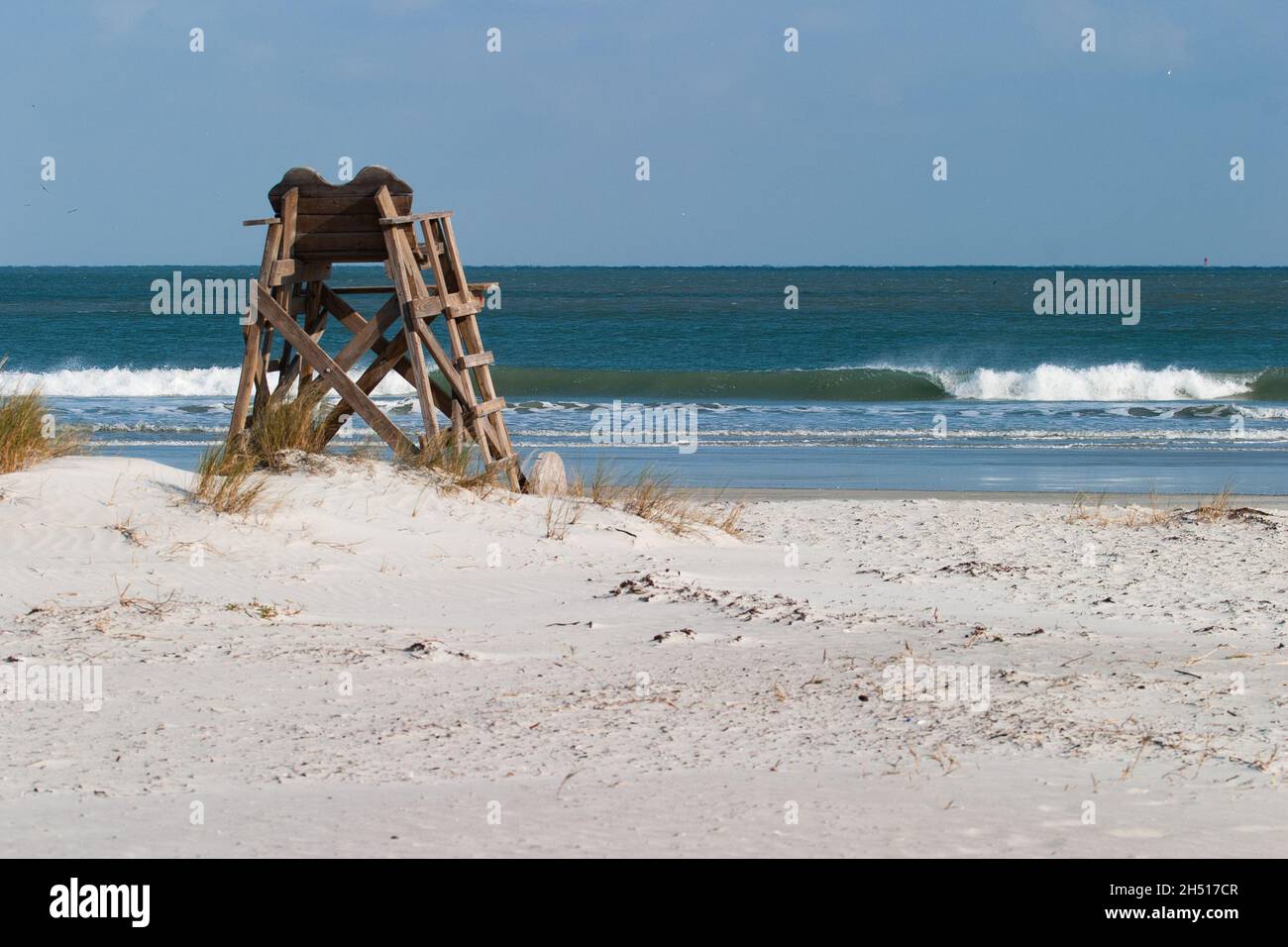 An empty lifeguard chair at a quiet surf side beach, a call to reconnection.