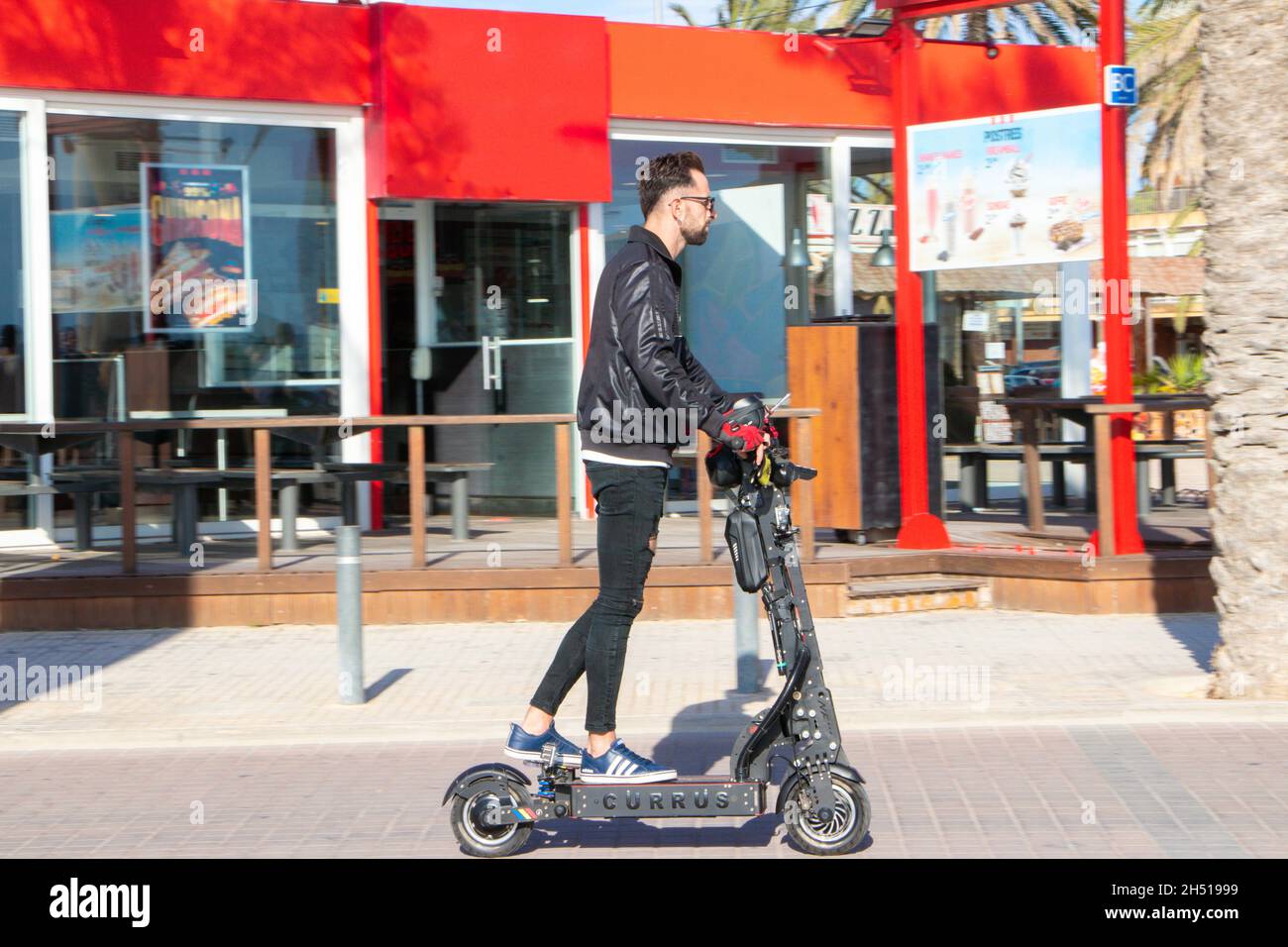 young man on electric scooter in Can Pastilla Mallorca Spain Stock Photo -  Alamy