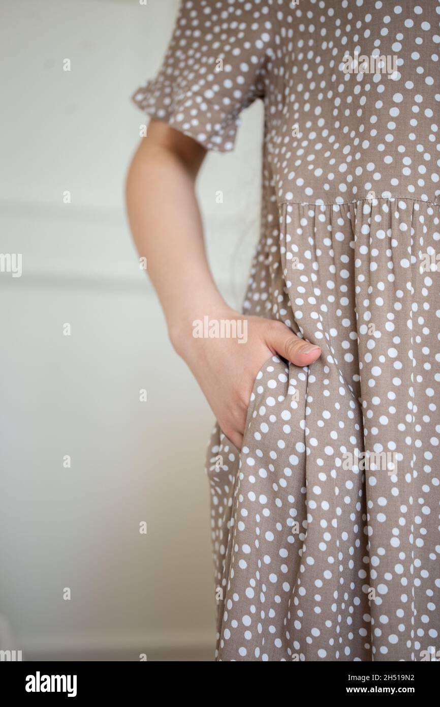 girl's hand in the pocket of the dress girl. Stock Photo