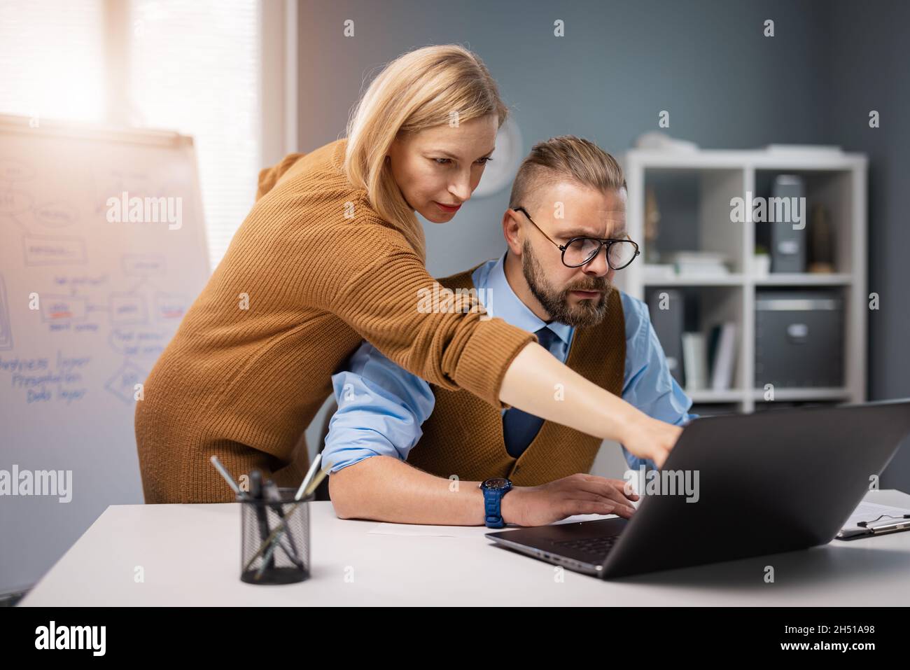 Two colleagues using laptop Stock Photo