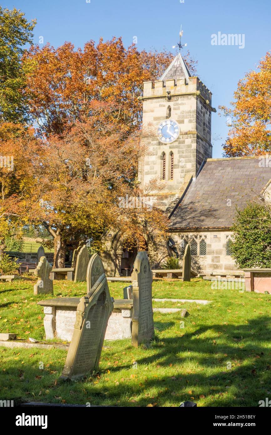 St Peter's parish Church churchyard and gravestones in the Autumn in the Cheshire village of Delamere, Stock Photo