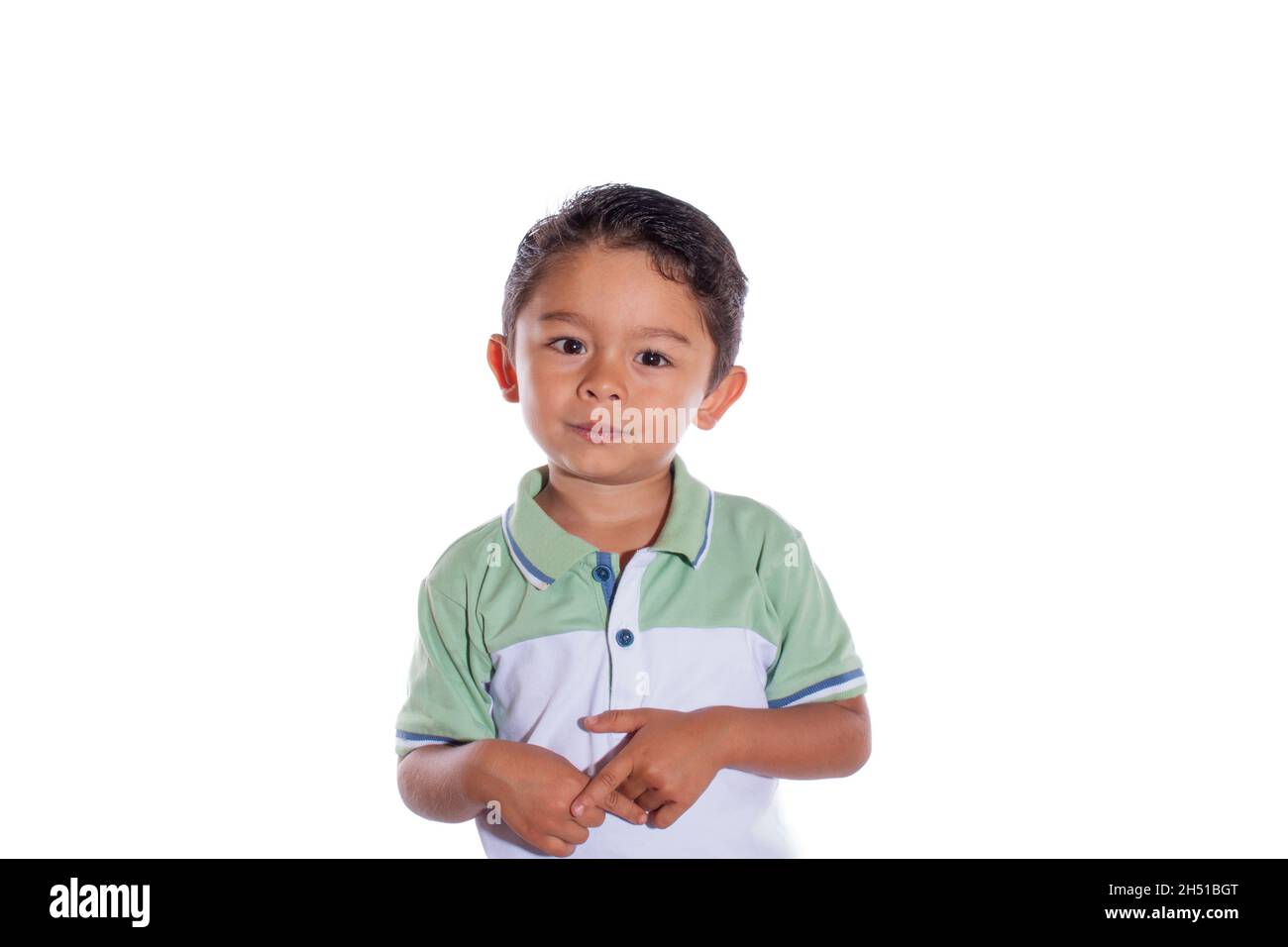 Cute boy looking at camera, isolated on white background. Nice looking latin boy with innocent look. Stock Photo