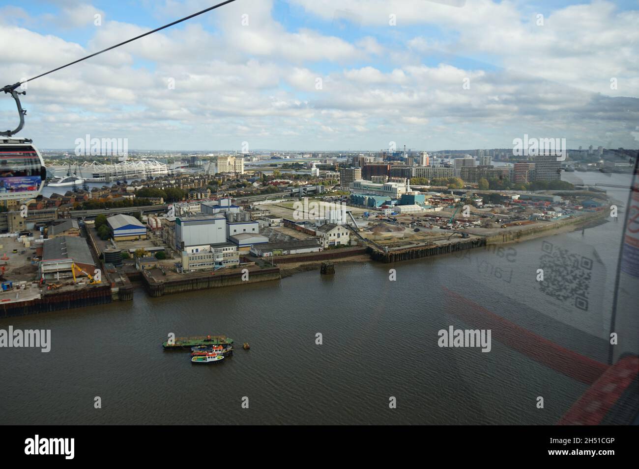 An aerial view of the Emirates Cable Cars approaching the Royal Dock over London River Thames in he U.K Stock Photo