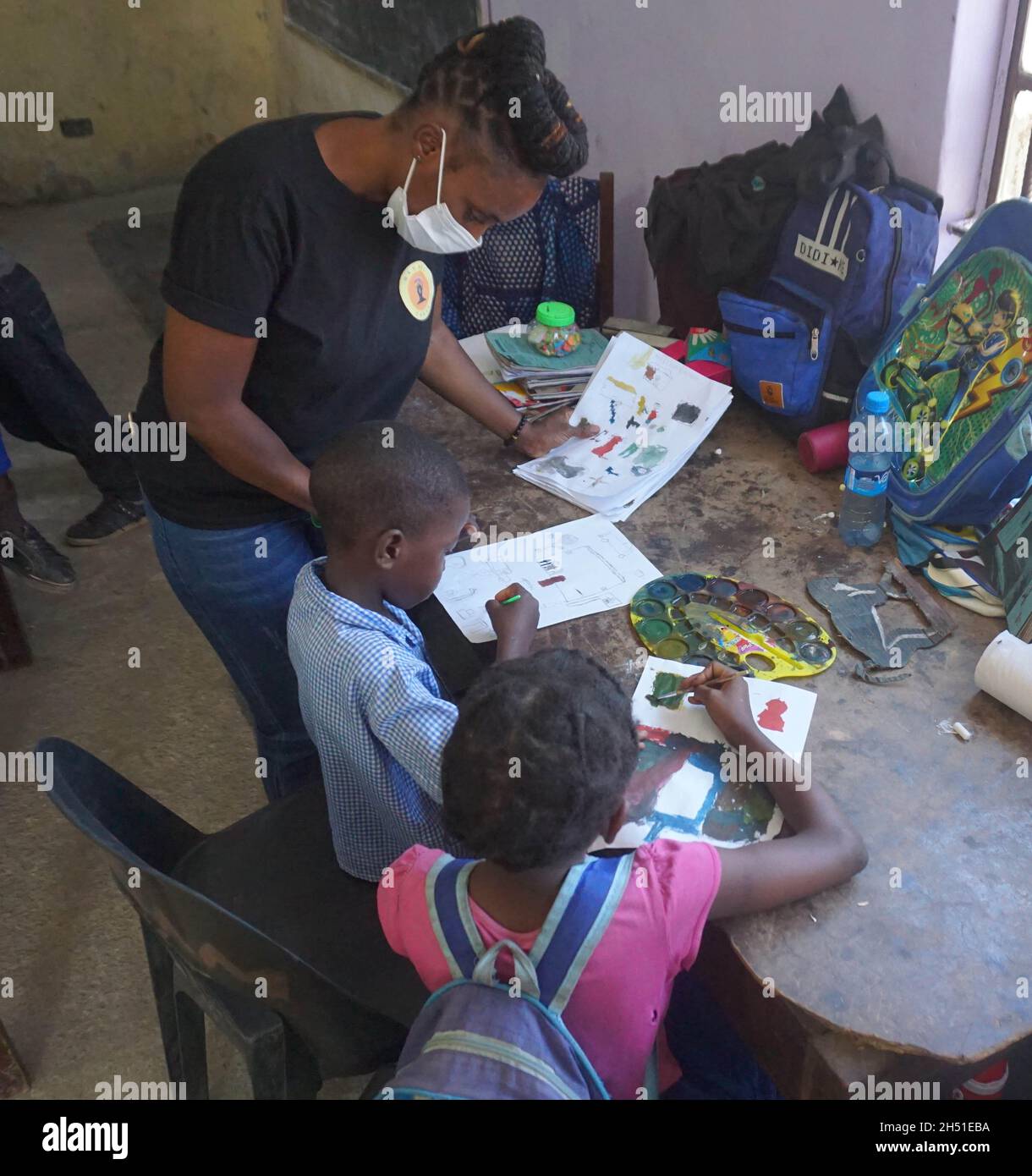 (211105) -- LUSAKA, Nov. 5, 2021 (Xinhua) -- A teacher instructs children to draw pictures at Orphan's Cry School in Lusaka, Zambia, on Oct. 29, 2021. Studies indicate that art improves communication and concentration. It also helps reduce feelings of isolation and increase an individual's confidence and self-awareness. It is against this backdrop that Nkhani Zanga, a Zambian-based charity, has been providing resources for children from less privileged backgrounds to enable them to explore and exploit their artistic potential in the area of music, poetry, drama and painting among others. (Phot Stock Photo